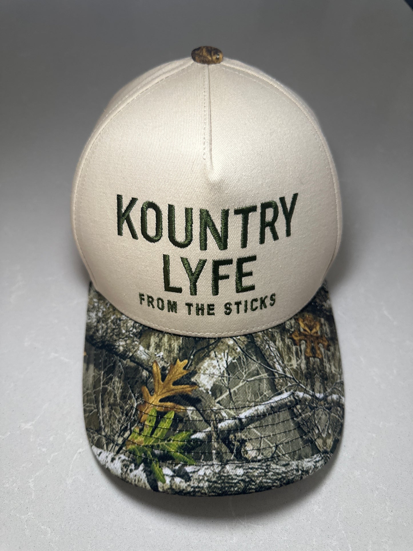 Kountry Lyfe “From The Sticks” Camo Trucker Hat